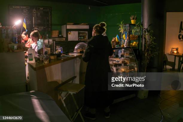 People in the cafe during a blackout after a Russian missile attack on Ukrainian power infrastructure in Kyiv, Ukraine, November 09, 2022