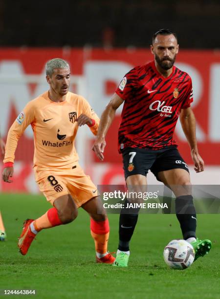 Atletico Madrid's French forward Antoine Griezmann vies with Mallorca's Kosovar forward Vedat Muriqi during the Spanish League football match between...