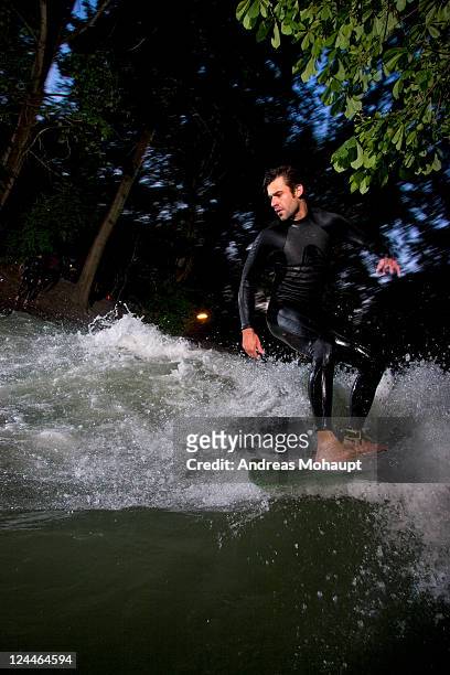 river surfer on eisbach - munich surfing stock pictures, royalty-free photos & images