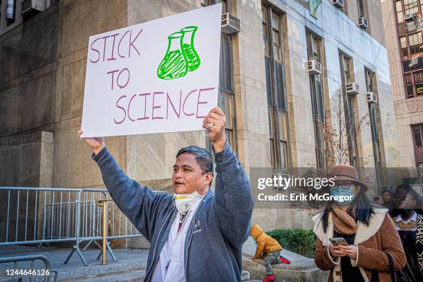 Participant seen holding a sign at the protest. Members of the AIDS Coalition To Unleash Power , Housing Works and GMHC held a protest outside the NY...