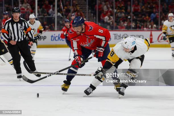 Alex Ovechkin of the Washington Capitals protects the puck as he is pressured by Brian Dumoulin of the Pittsburgh Penguins during a game at Capital...