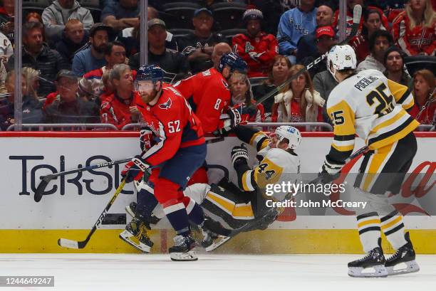 Alex Ovechkin of the Washington Capitals finishes a check on Jan Rutta of the Pittsburgh Penguins during a game at Capital One Arena on November 9,...