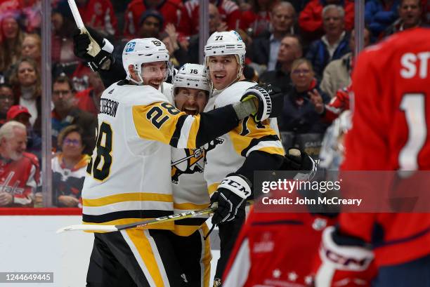 Jason Zucker of the Pittsburgh Penguins celebrates a goal against the Washington Capitals with Marcus Pettersson and Evgeni Malkin at Capital One...