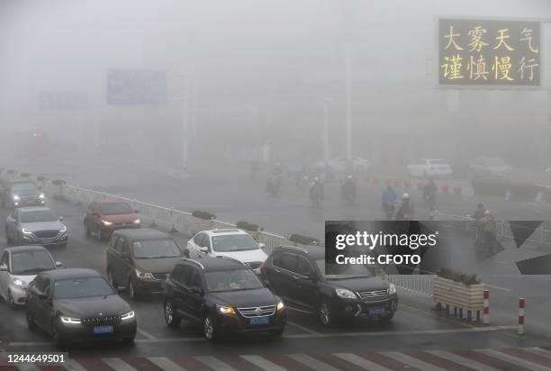 People wear masks as they travel in heavy fog in Huai 'an city, Jiangsu province, China, Nov 10, 2022.