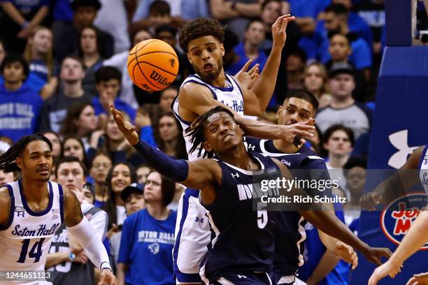 Myles Foster of the Monmouth Hawks attempts to pull in a rebound against Tray Jackson of the Seton Hall Pirates during the second half of a college...