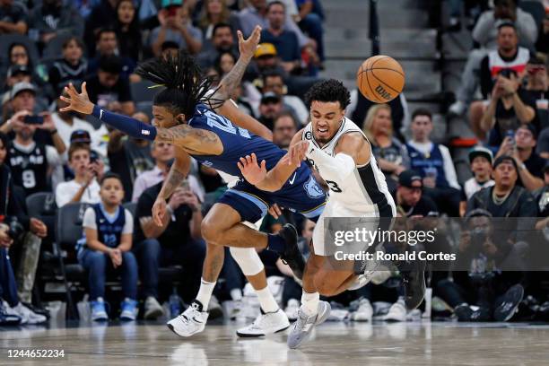 Tre Jones of the San Antonio Spurs tries for a steal on Ja Morant of the Memphis Grizzlies in the second half at AT&T Center on November 09, 2022 in...