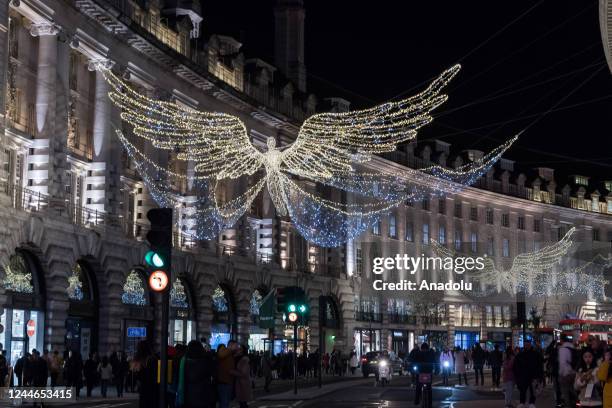 Shoppers walk in Regent Street as the 'The Spirit of Christmas' festive lights are switched on in London, United Kingdom on November 09, 2022.