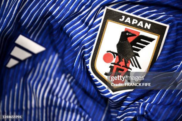 Picture taken on November 8, 2022 in Paris, shows the logo on a jersey of the Japan national football team for the Football FIFA World Cup 2022 in...