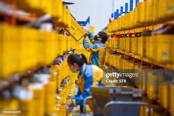 An employee prepares items for delivery ahead of the Singles' Day shopping festival which falls on November 11, at a logistics center in Nanjing, in...