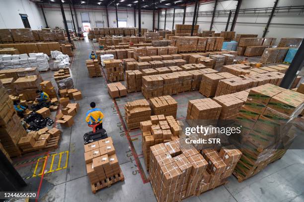 An employee transfers items for delivery ahead of the Singles' Day shopping festival which falls on November 11, at a logistics center in Nanjing, in...