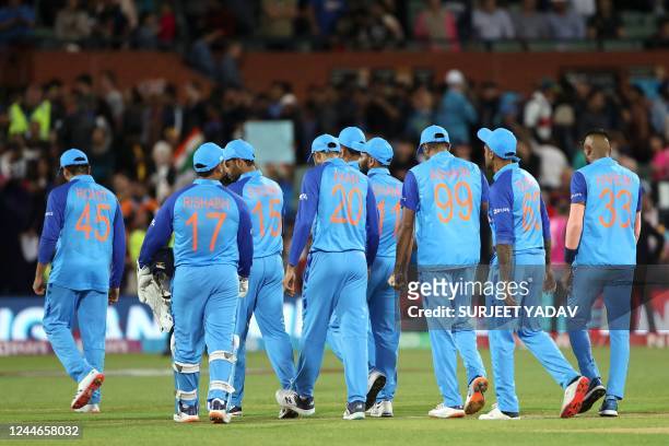 India's Captain Rohit Sharma escorts his team off the field after their defeat during the ICC men's Twenty20 World Cup 2022 semi-final cricket match...