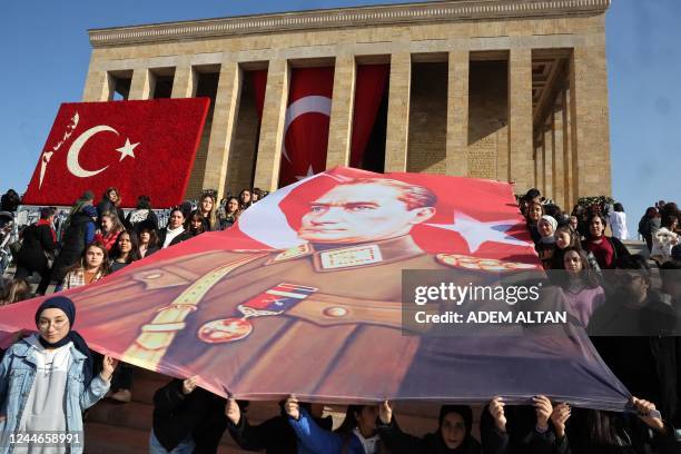 People holds Turkish Republic founder and first president, Mustafa Kemal Ataturk portrait as they visit Anitkabir mausoleum to mark the 84th...