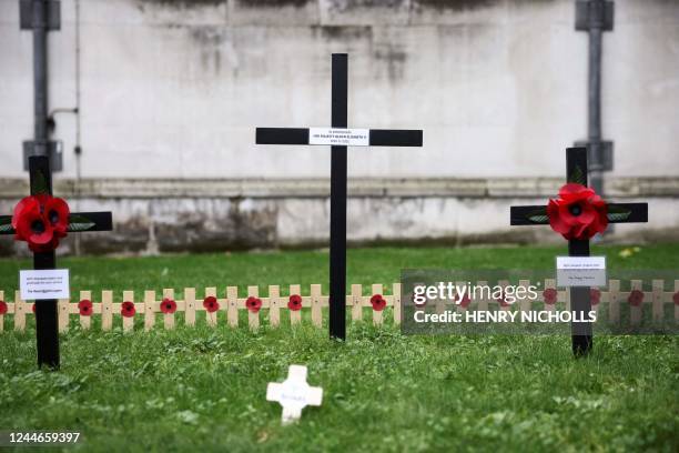 Memorial cross bearing the name of Britain's late Queen Elizabeth II is displayed during a ceremony at the Field of Remembrance at Westminster Abbey...