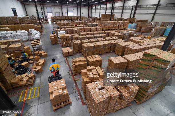 Workers labor at a logistics center of Suning in Nanjing in east China's Jiangsu province Thursday, Nov. 10 in preparation for the next day's online...