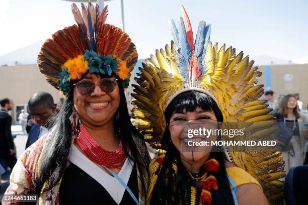 Attendees from Brazil dressed in traditional clothing pose for a picture at the Sharm el-Sheikh International Convention Centre, in Egypt's Red Sea...