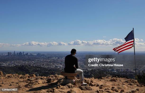 Los Angeles resident Brian Park takes a break after hiking to the Wisdom Tree in Griffith Park on Wednesday, November 9, 2022.