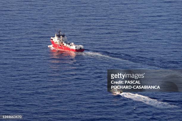 An aerial picture taken on November 10, 2022 shows the humanitarian boat Ocean viking escorted by a military boat cruising off the coast of Northtern...
