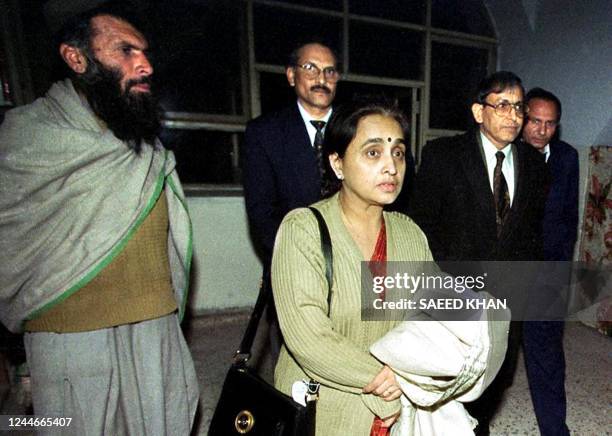 An unidentified Indian doctor , along with other high officials, enters a meeting hall at Kandahar airport in southern Afghanistan, 27 December 1999....