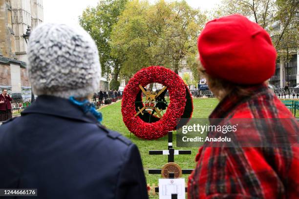 Women look at a giant Poppy wreath in the Field of Remembrance at Westminster Abbey in London, Britain, on November 10, 2022 ahead of Armistice Day...