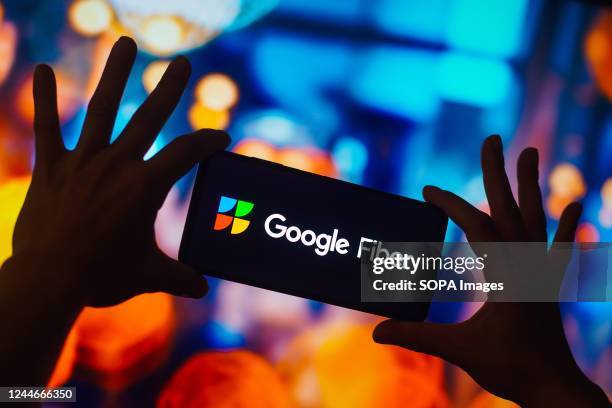 In this photo illustration, the Google Fiber logo is displayed on a smartphone screen.
