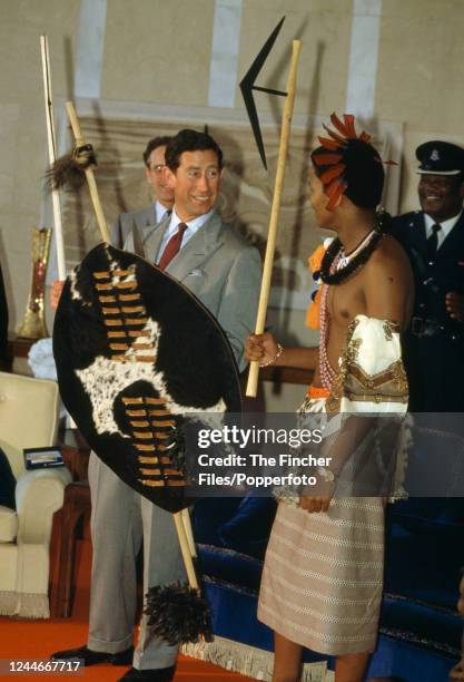 Prince Charles with King Mswati III holding a traditional Swaziland shield while visiting Mbabane, Swaziland during a trip to Africa in his capacity...