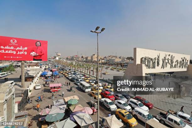 This picture shows traffic in Baghdad's Tahrir Square with the iconic Freedom Monument, a 50-metre long bas relief that honours the 1950 revolution...