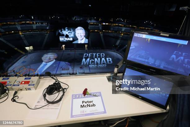 Carnation and placard tribute rest at the seat of former NHL player and Colorado Avalanche commentator Peter McNab prior to the game between the...