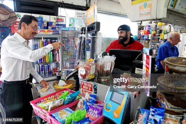 Customer buys a lottery ticket from Danny Chahayed center, son of Joseph Chahayed far right, owner of Joes Service Station, now an ExxonMobil...