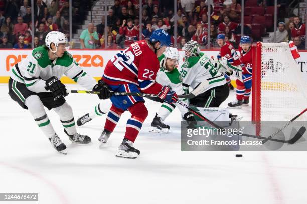 Cole Caufield of the Montreal Canadiens controls the puck while being challenged Jason Robertson of by the Dallas Stars during the second period in...