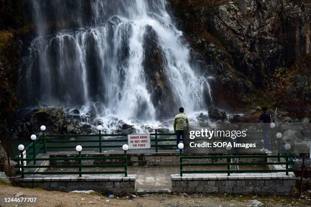 Visitors view the Drang waterfall during a cold autumn day in Drang about 40kms from Srinagar, the summer capital of Jammu and Kashmir.