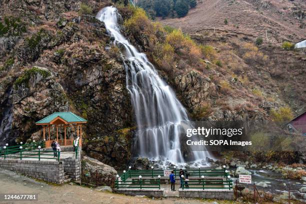 Visitors view the Drang waterfall during a cold autumn day in Drang about 40kms from Srinagar, the summer capital of Jammu and Kashmir.