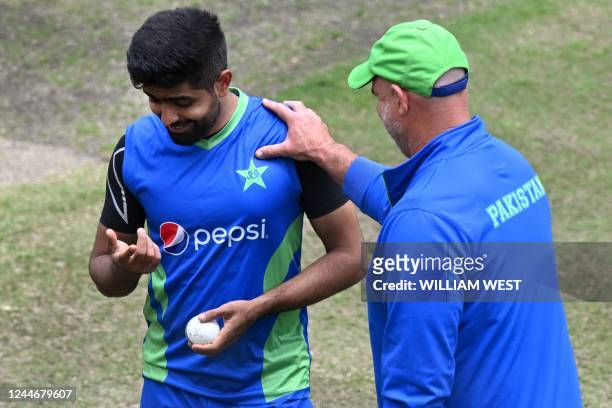 Pakistan batting coach Matthew Hayden speaks with player Babar Azam during a training session in Melbourne on November 11 ahead of their ICC men's...