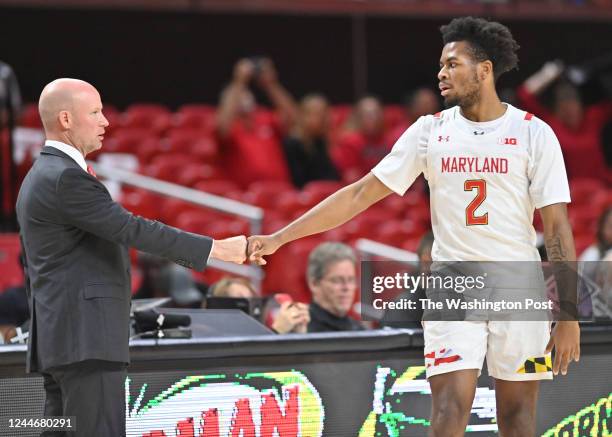 Maryland head coach Kevin Willard fist bumps guard Jahari Long during action against Western Carolina at Xfinity Center on November 10, 2022.