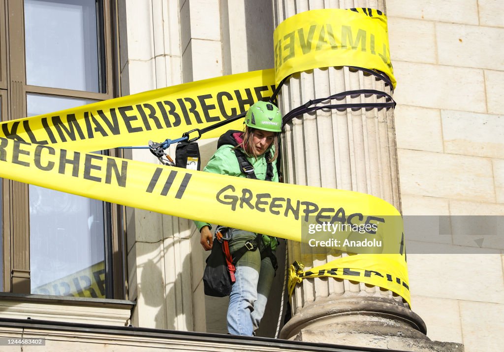 Environmental Attach Greenpeace activists attach a crime scene tape around columns of the ...