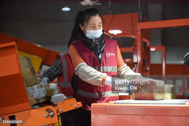 An employee sorts packages for delivery during the Singles' Day shopping festival at a logistics center in Donghai, in China's eastern Jiangsu...