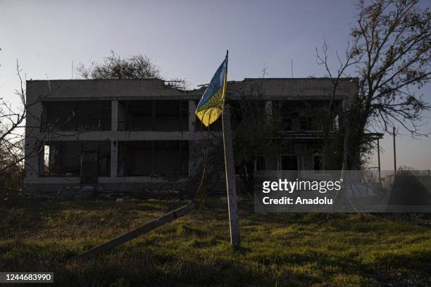 View of the Ukrainian flag in front of a damaged settlement in Potemkin village which is recently retaken from Russian Forces, Kherson Oblast,...