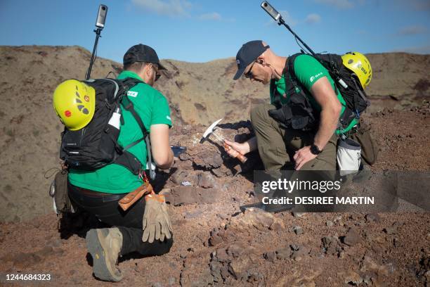 German astronaut Alexander Gerst collects rock on the summit of an ancient volcano during a training program to learn how to explore the Moon and...