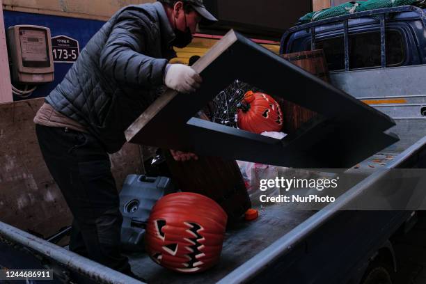 Halloween decorations are being removed by a worker at the site of the 10.29 Itaewon disaster on November 11, 2022 in Seoul, South Korea. The site of...