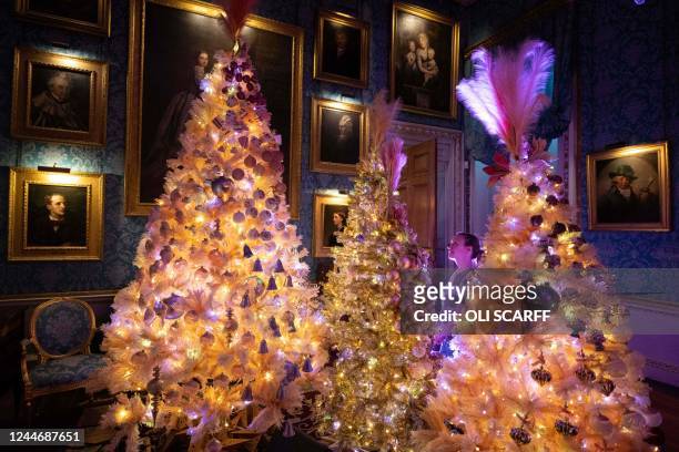 Member of staff admires the Christmas displays in the rooms of Castle Howard stately home, entitled 'Into the Woods: A Fairytale Christmas', on...