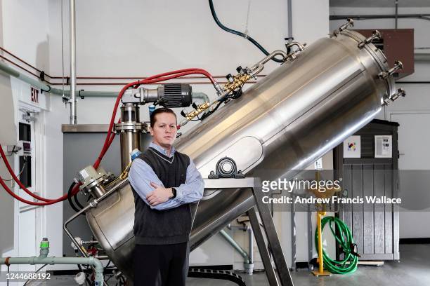 Newcastle Funeral Home owner Trevor Charbonneau stands next to the funeral home's alkaline hydrolysis machine on December 14, 2019.