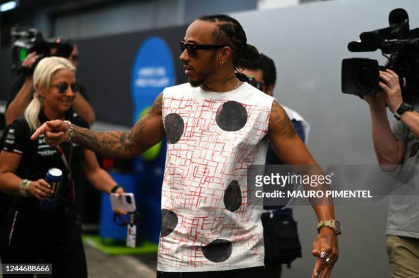 Mercedes' British driver Lewis Hamilton arrives to the paddock area at the Interlagos racetrack in Sao Paulo, Brazil, on November 11 two days ahead...