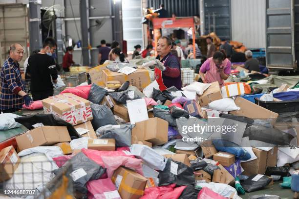 An employee sorts packages for delivery during the Singles' Day shopping festival at a logistics center in Lianyungang, in China's eastern Jiangsu...