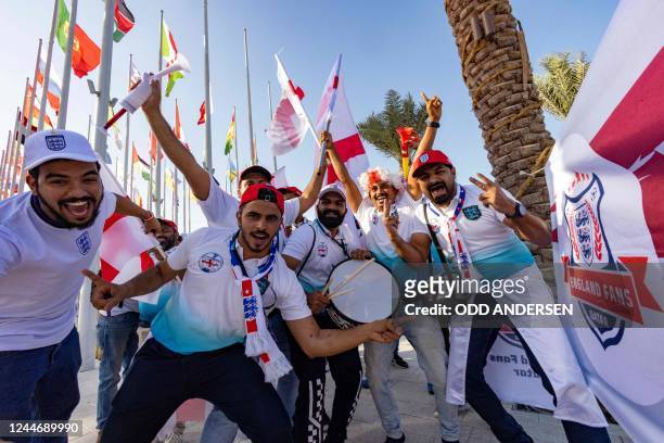 Football fans supporting England cheer in Doha on November 11 ahead of the Qatar 2022 FIFA World Cup football tournament.
