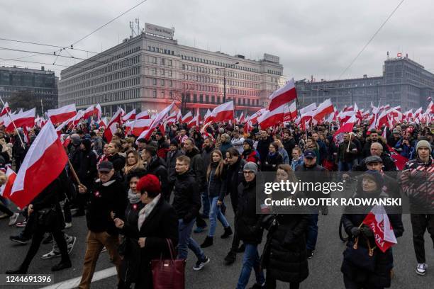 Participants with Polish flags take part in the country's Independence Day march organised by nationalist groups in Warsaw on November 11, 2022. -...