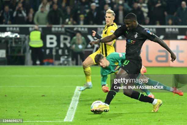 Moenchengladbach's French forward Marcus Thuram shoots to scoring a goal during the German first division Bundesliga football match between Borussia...