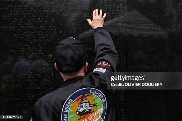 Veteran looks at the names on the Vietnam Veterans Memorial during a Veterans Day observance on the 40th anniversary of the memorial in Washington...