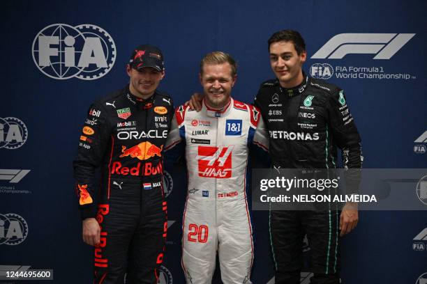 First-placed Haas F1 Team's Danish driver Kevin Magnussen poses with second-placed Red Bull Racing's Dutch driver Max Verstappen and third-placed...