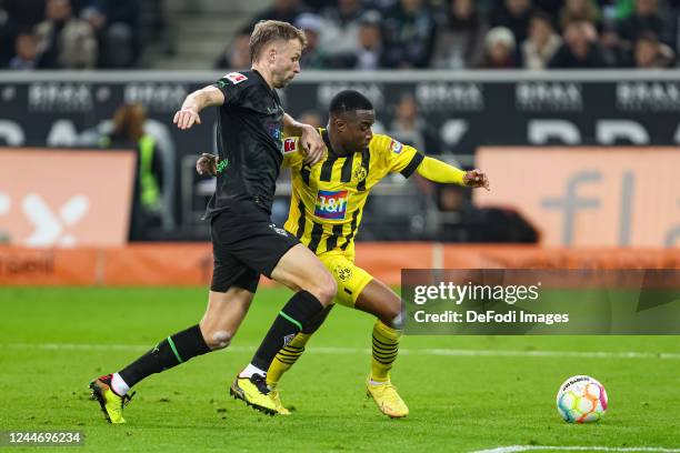 Marvin Friedrich of Borussia Moenchengladbach and Youssoufa Moukoko of Borussia Dortmund battle for the ball during the Bundesliga match between...