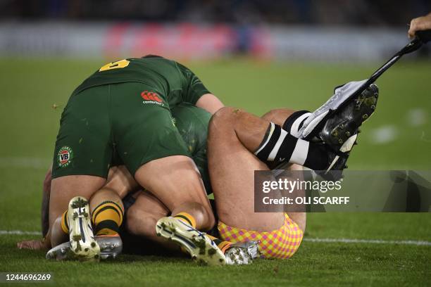 New Zealand's Isaiah Papali'i is tackled as his shorts is ripped during the 2021 rugby league World Cup men's semi-final match between Australia and...