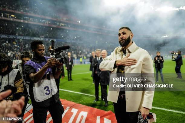 Real Madrid's French forward Karim Benzema gestures to fans during the presentation of his Ballon d'Or trophy at half time of the French L1 football...
